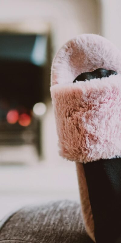 Relaxing by the fireplace with fuzzy slippers and warm socks indoors.